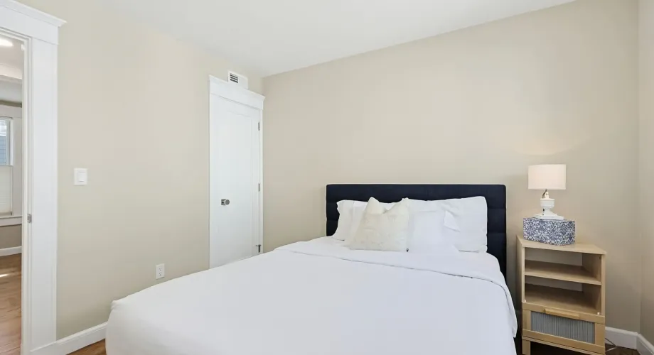 Bright contemporary bedroom with queen bed in a Cambridge rental near Central Square