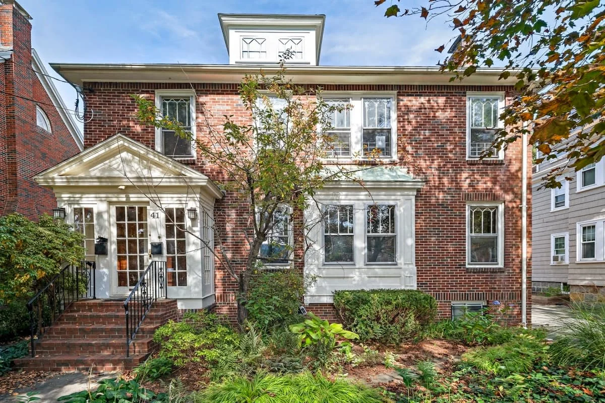 Red brick Boston brownstone with ivy and front garden, a classic stay for Boston in fall