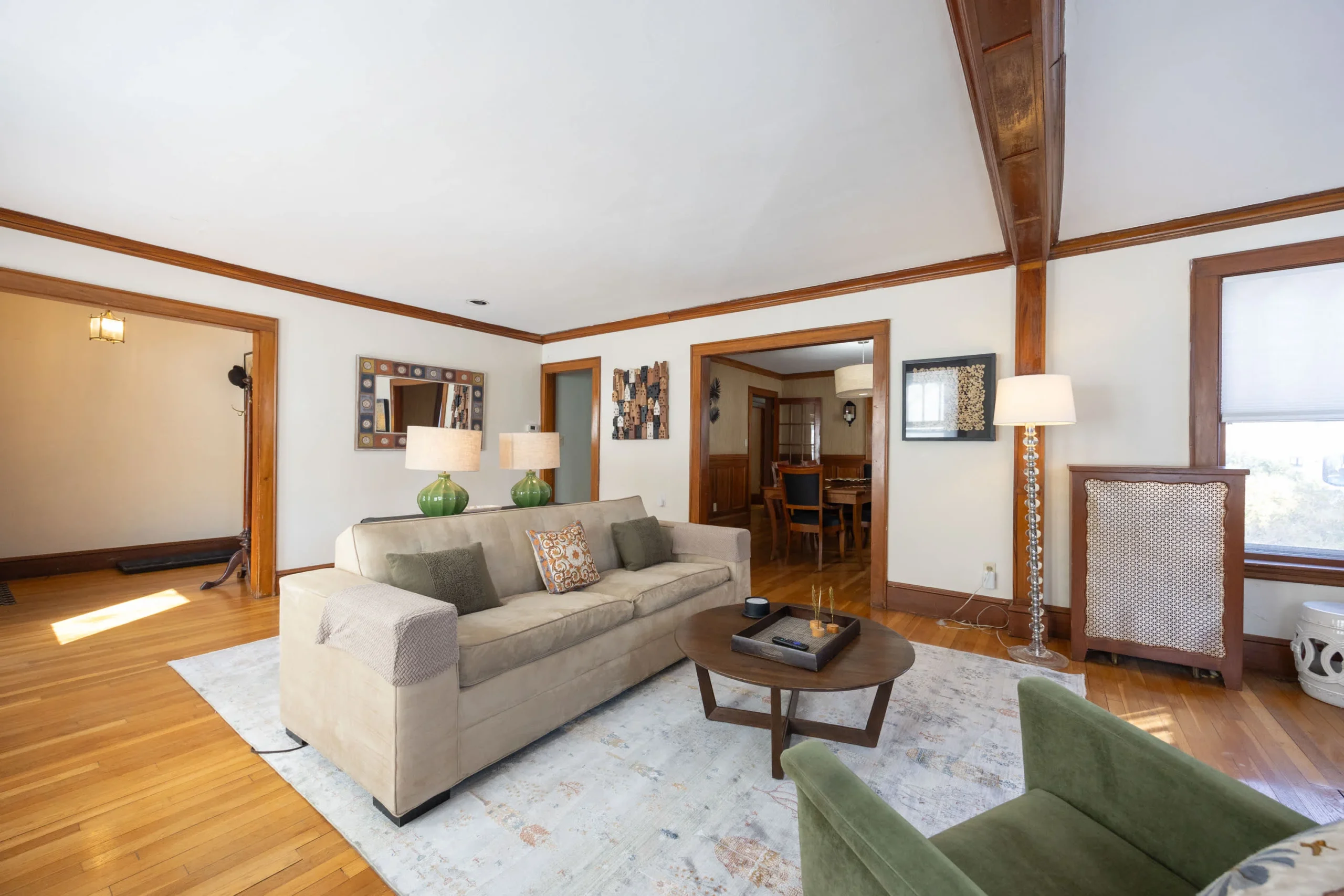Spacious living room with wood beams and hardwood floors in Boston group vacation rental